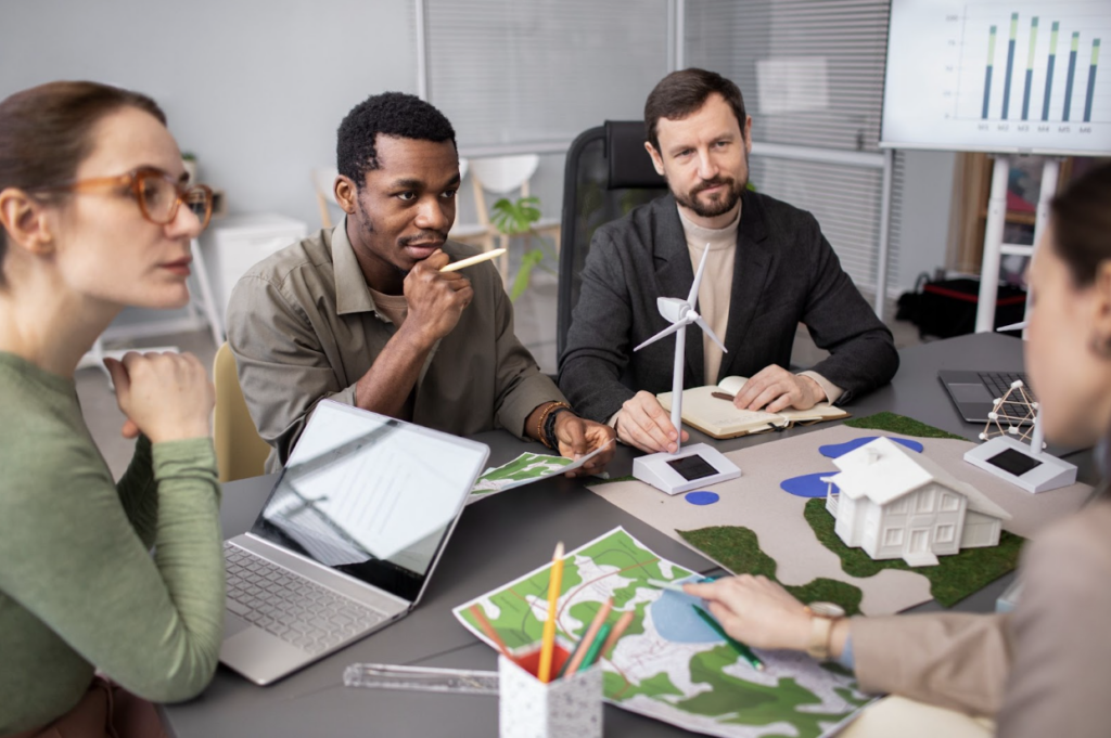 Screenshot 2026 01 22 at 18.51.53 quatro pessoas sentadas em um escritório, conversando sobre a mudança da ifrs s1 e s2